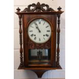 A Victorian walnut cased wall hanging 8 day clock, the case having an acorn and scroll shaped top