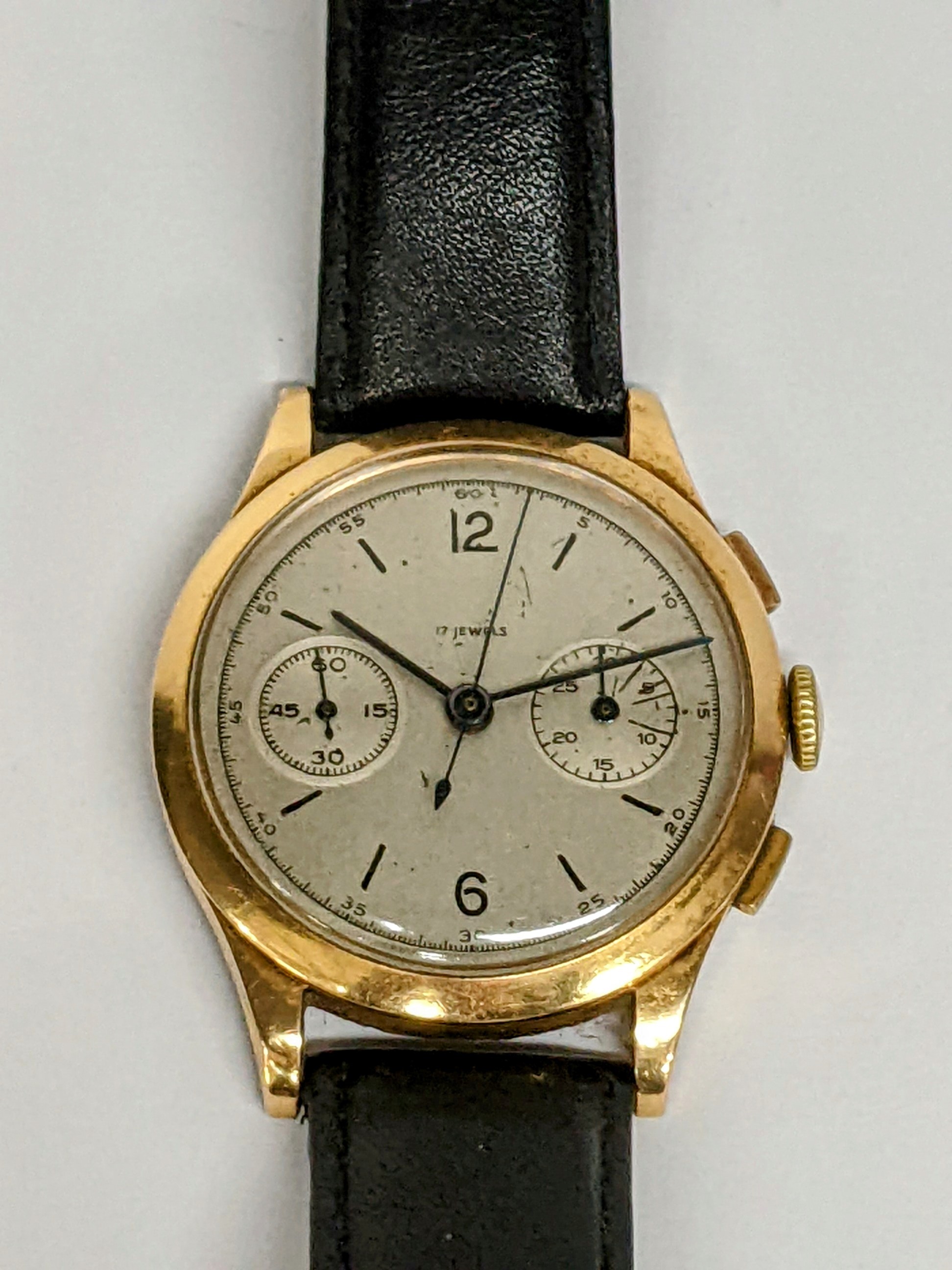 A mid 20th century 18ct gold, chronograph manual wind, gents wristwatch, having a silvered dial with