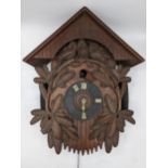 A late 19th century black forest cuckoo clock, the chalet case carved with three birds perched on