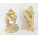 Two African soapstone figural sculptures, one modelled as a man holding his foot to his head, the