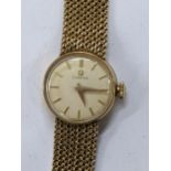 A Omega manual wind ladies 9ct gold wristwatch, circa 1961, having a white enamel dial with gilt