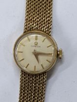 A Omega manual wind ladies 9ct gold wristwatch, circa 1961, having a white enamel dial with gilt