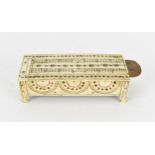 An early 19th century Prisoner of war carved bone domino box, of rectangular form with sliding