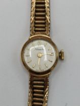 A Nivada manual wind ladies 9ct wristwatch, having a white enamel dial with baton markers, the 17