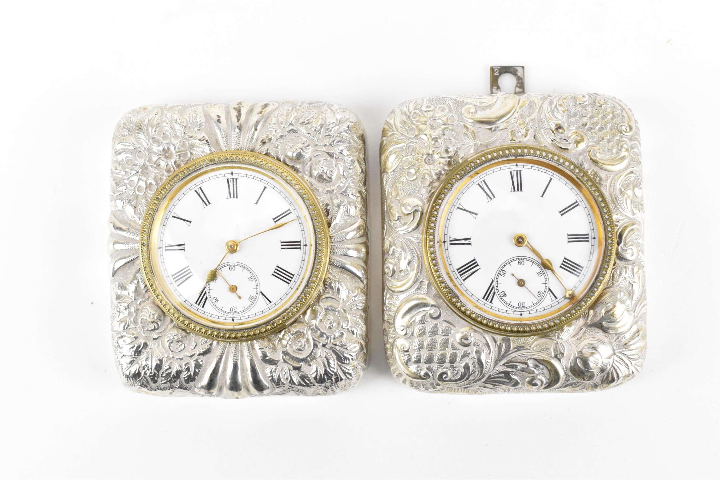 A pair of late Victorian silver cased travel clocks, Birmingham 1897, the cases embossed with