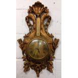 A mid 20th century French Louis XVI style wall hanging clock, the carved gilt wood case having a