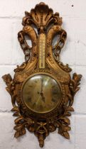 A mid 20th century French Louis XVI style wall hanging clock, the carved gilt wood case having a