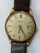 A Nivada automatic, 9ct gold cased wristwatch having a silvered dial with central seconds, baton