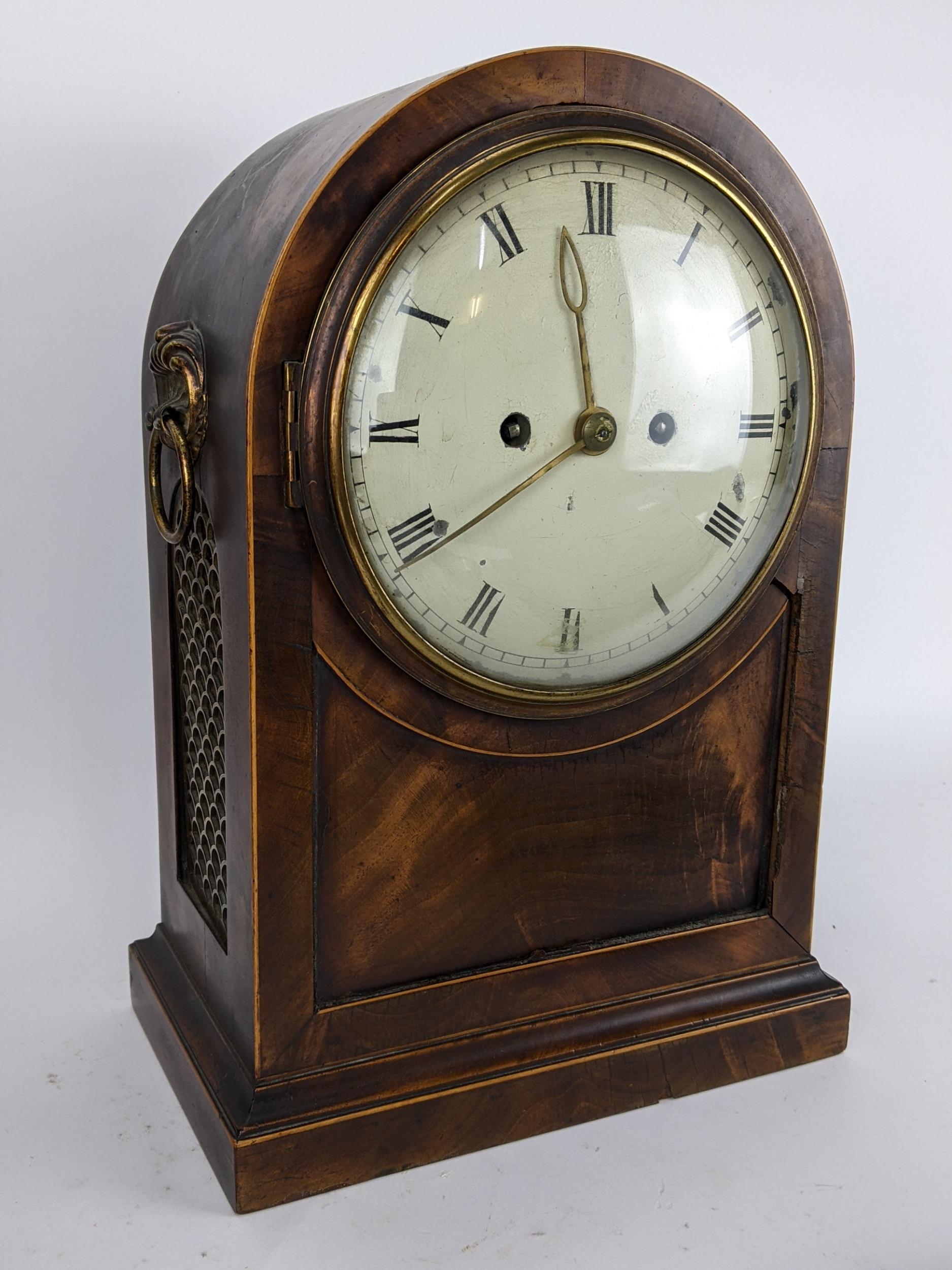 A Regency mahogany bracket clock having an arched top case with boxwood string inlaid, two ring