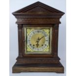 A late 19th century oak mantle clock, the case of architectural design having composite Greek