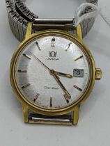 An Omega Geneve, manual winding gents gold plated wristwatch, having a silvered dial with centre