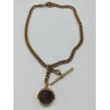 A Victorian 9ct gold Double Albert curb link watch chain having a T-bar and single dog clip, an O