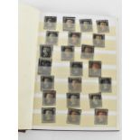 A stamp album containing twenty-two penny blacks, a collection of penny reds, blue two pence,