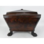 A Regency style sarcophagus shaped mahogany cellerette, with gadrooned hinged top opening tin