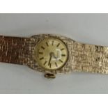 A Certina manual wind ladies 9ct wristwatch, having a gilt dial with baton markers, the 17 jewels