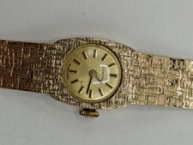 A Certina manual wind ladies 9ct wristwatch, having a gilt dial with baton markers, the 17 jewels