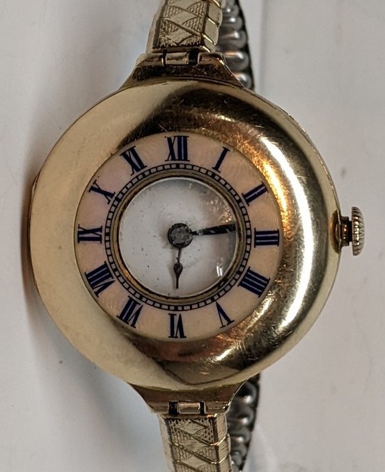 An early 20th century 9ct gold ladies half hunter wristwatch, having a white enamel dial, blued