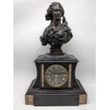 A late 19th century French black slate cased mantel clock surmounted by a bronze bust of a female