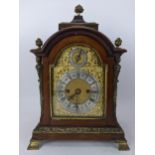 A late 19th/early 20th century mahogany bracket clock, the case having basket of flowers finials,