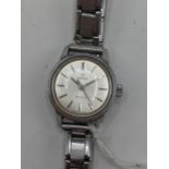 An Omega Geneve, ladies, stainless steel, manual wind wristwatch, having a silvered dial with centre