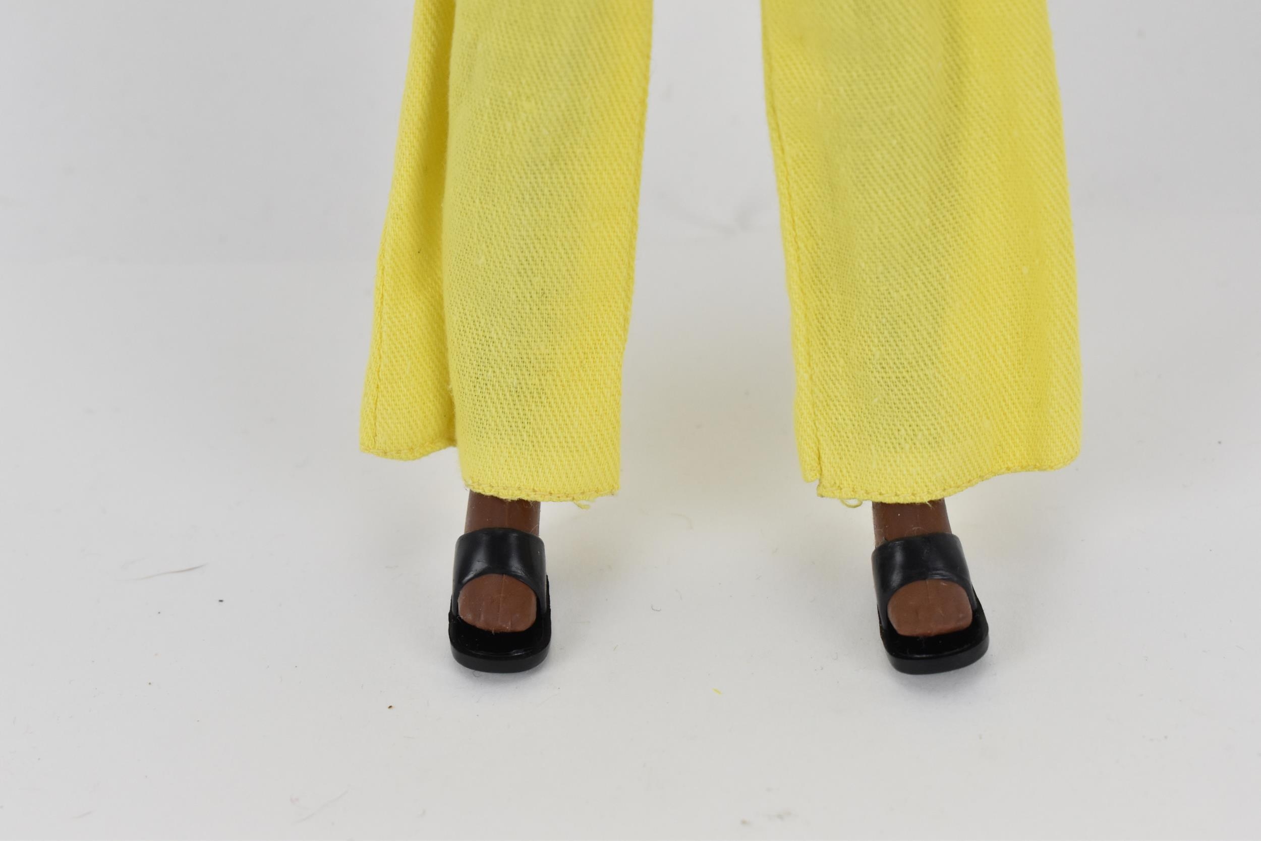 A vintage Sindy's friend Gayle doll in a yellow pant suit, with additional black mules, with painted - Image 3 of 5