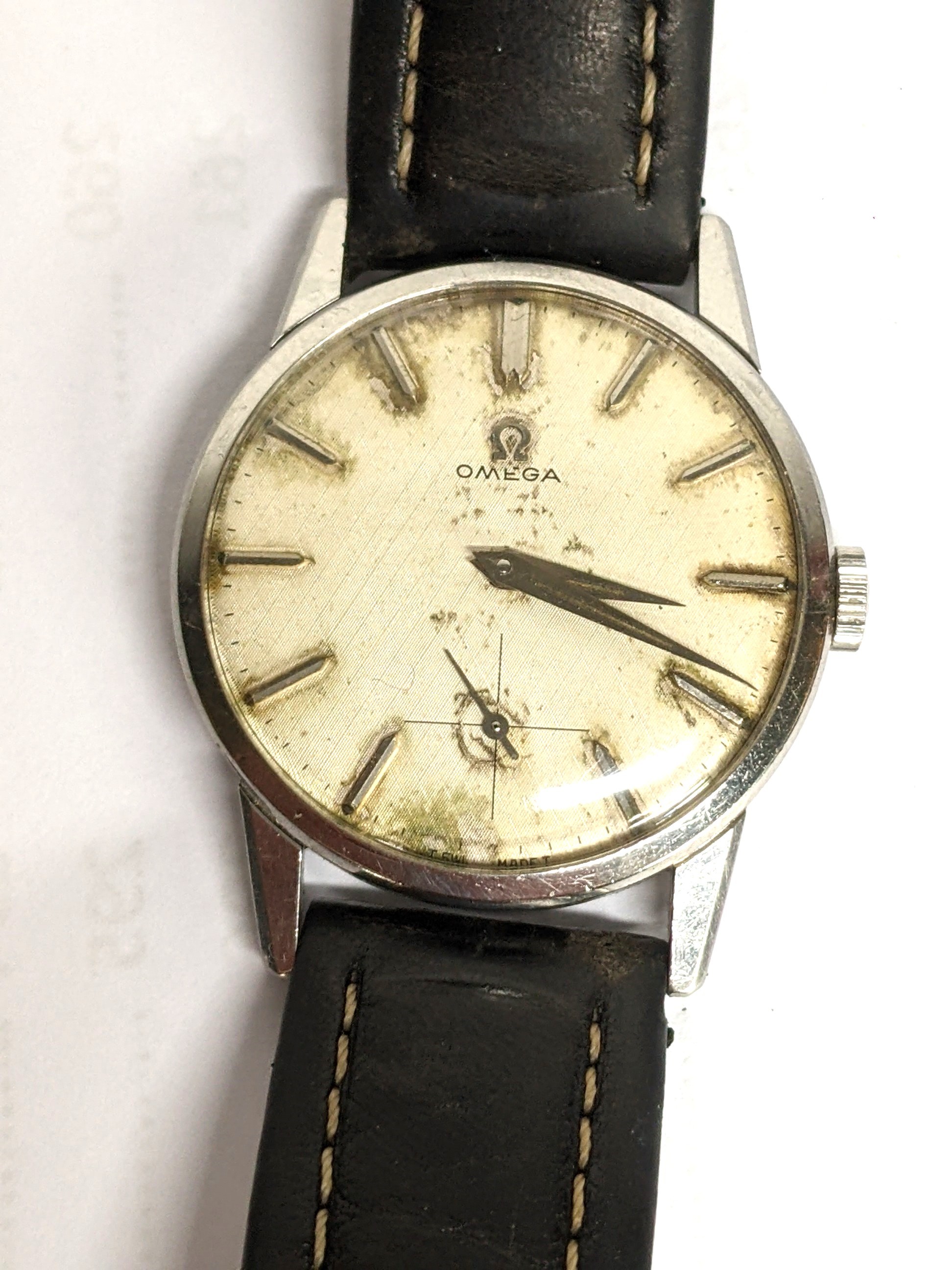 An Omega, manual winding gents stainless steel wristwatch, having a textured dial with subsidiary