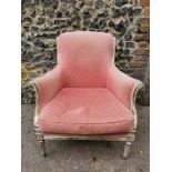 A Louis XVI style painted armchair, with pink upholstery, the chanelled frame with curved back and