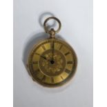 A Victorian 14ct gold, open faced fob watch, having a gilt engraved floral dial, blued hands and
