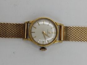 A Omega manual wind ladies 18ct gold wristwatch, circa 1961, having a white enamel dial with gilt