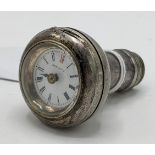 An early 20th century silver plated walking stick handle incorporating a watch to the top, the white