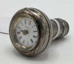 An early 20th century silver plated walking stick handle incorporating a watch to the top, the white