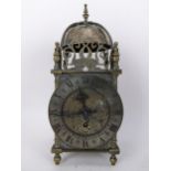 An early 20th century brass lantern clock, in the 18th century style the four post case with 5" dial