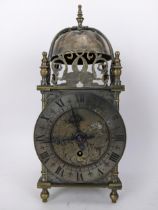 An early 20th century brass lantern clock, in the 18th century style the four post case with 5" dial
