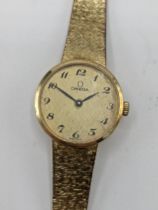 A Omega manual wind ladies 14ct gold wristwatch, circa 1973, having a gilt dial with Arabic