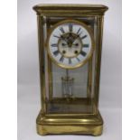 A late 19th century large French gilt brass mantle clock having a white enamel chapter ring with