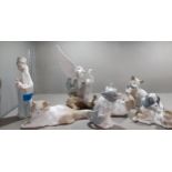 A group of five Nao models of cats, dogs and herons together with two Lladro models of a young boy