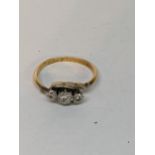 An 18ct yellow gold and platinum set three stone diamond ring, total weight 2.5g Location: RING