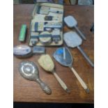 Dressing table items to include brushes and mirrors, a travelling set, and six silver lidded