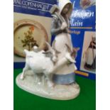 Royal Copenhagen - a farmer's girl holding a mallet with two goats by her side, 22cm h x 19cm w,