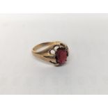 A 9ct gold ring inset with central red stone, size T1/2, 5g, and a 9ct gold ring with black tablet