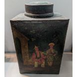 An early 20th century metal green Japanned tea canister, depicting two figures and stamped '12' to