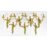 A set of seven Louis XV style ormolu twin-branch wall lights, each with two scroll arms cast with