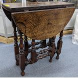 An early 20th century small oak gateleg table having two fall flaps and turned legs, 58cm h x 54.5cm