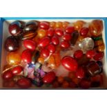 A quantity of loose beads and cabochons to include amber, cherry amber and rose quartz examples.
