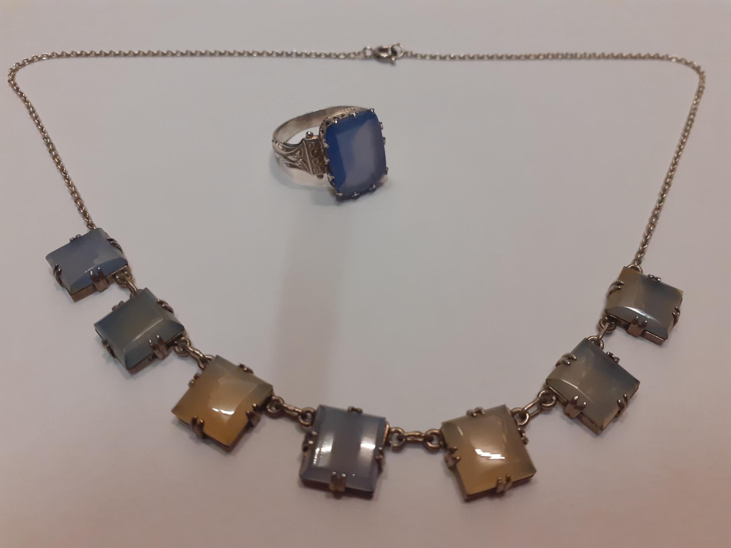 A silver necklace set with 7 chalcedony tablets and a matching ring