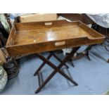 A 19th century mahogany butlers tray topped table with folding base, 79cm x 70.5cm w Location: