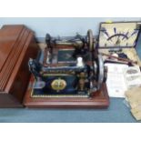 A Singer sewing machine, hand cranked, serial no S114759, circa 1906 together with a leather cased