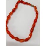 A vintage amber necklace having 25 irregular shaped beads. Location:Cab