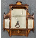 An Edwardian Sheraton revival rosewood overmantel having bevelled glass mirrors, turned columns