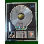 A framed presentation platinum awards disc recognising The Beatles worldwide sales of the Apple